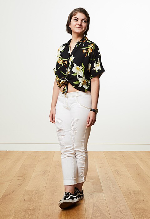 Rosie wearing a tropical print shirt with white jeans