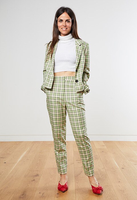 Celia wearing a green check suit
