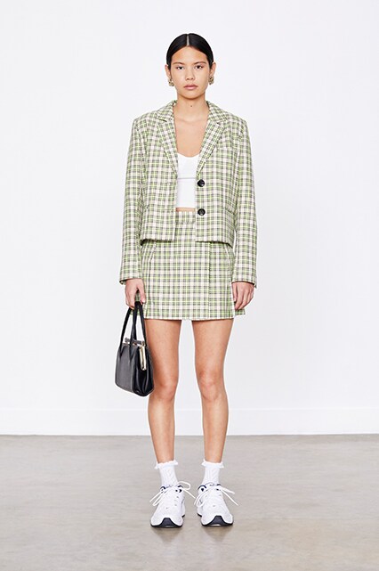 Model wearing a green check skirt-suit