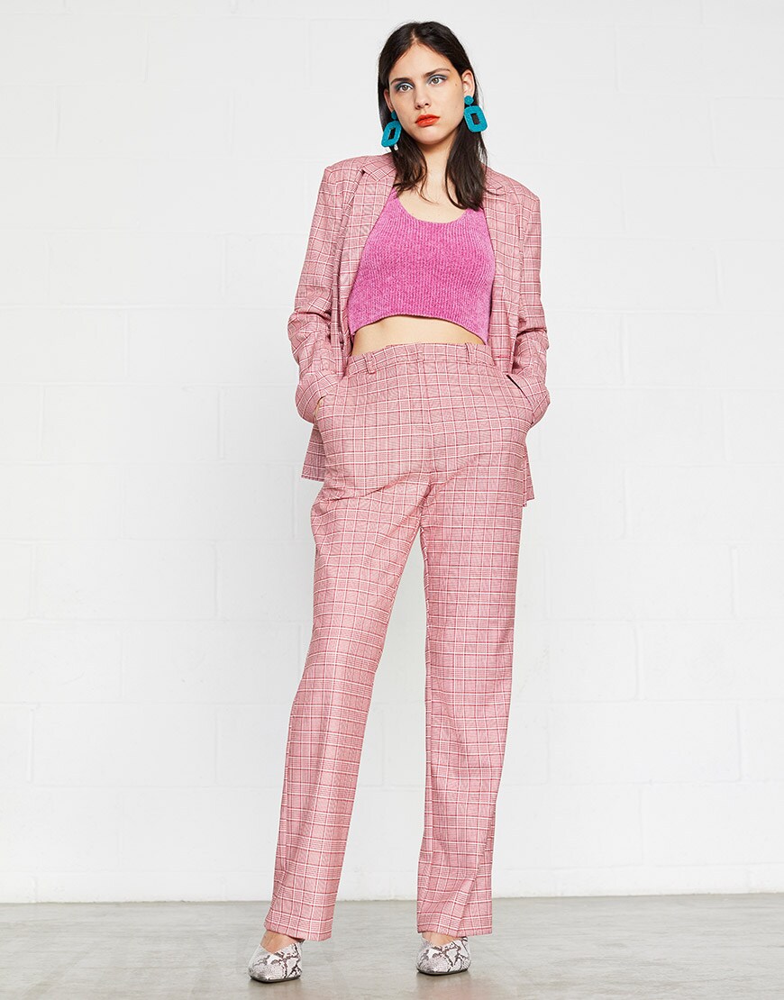 ASOS model wearing a pink check suit, pink crop top and blue earrings | ASOS Style Feed