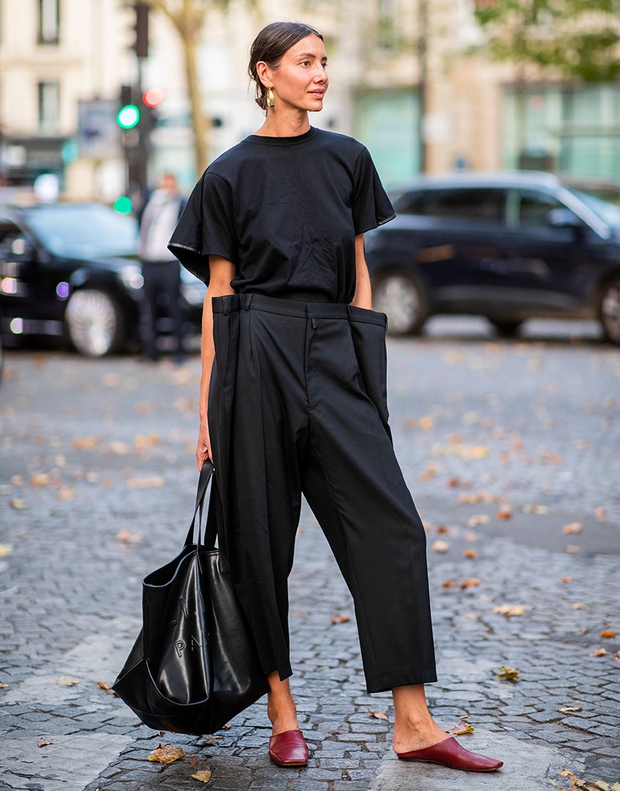 A street styler wears black trousers and mules at Paris couture  | ASOS Fashion & Beauty Feed
