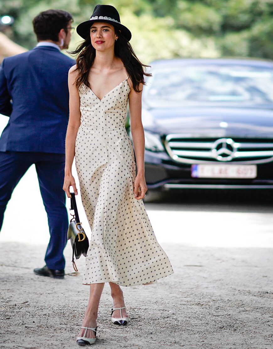 A street styler wears a slip dress and a trilby at Paris couture  | ASOS Fashion & Beauty Feed