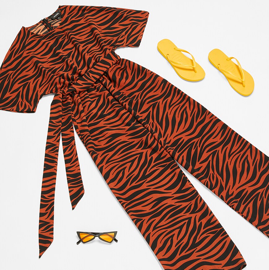 Tiger stripes jumpsuit from Monki with flip flops and sunglasses