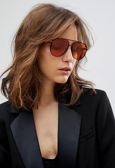 Gafas de sol estilo aviador de tendencia en metal negro con lentes naranja de ASOS. Top 10 de las gafas de sol que son tendencia este 2018.