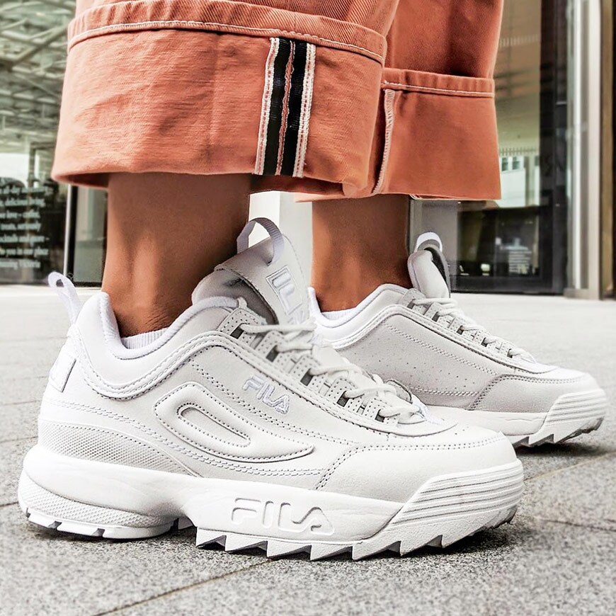 ASOS Lesley wearing chunky Fila trainers with rolled up jeans