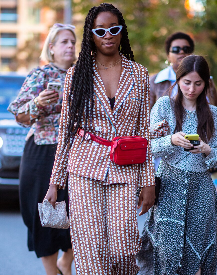 Street styler wearing a belt bag on the runway at London Fashion Week | ASOS Style Feed