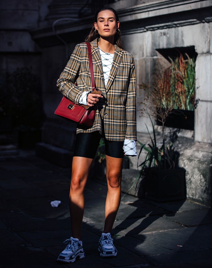 Street styler in legging shorts and a checked blazer