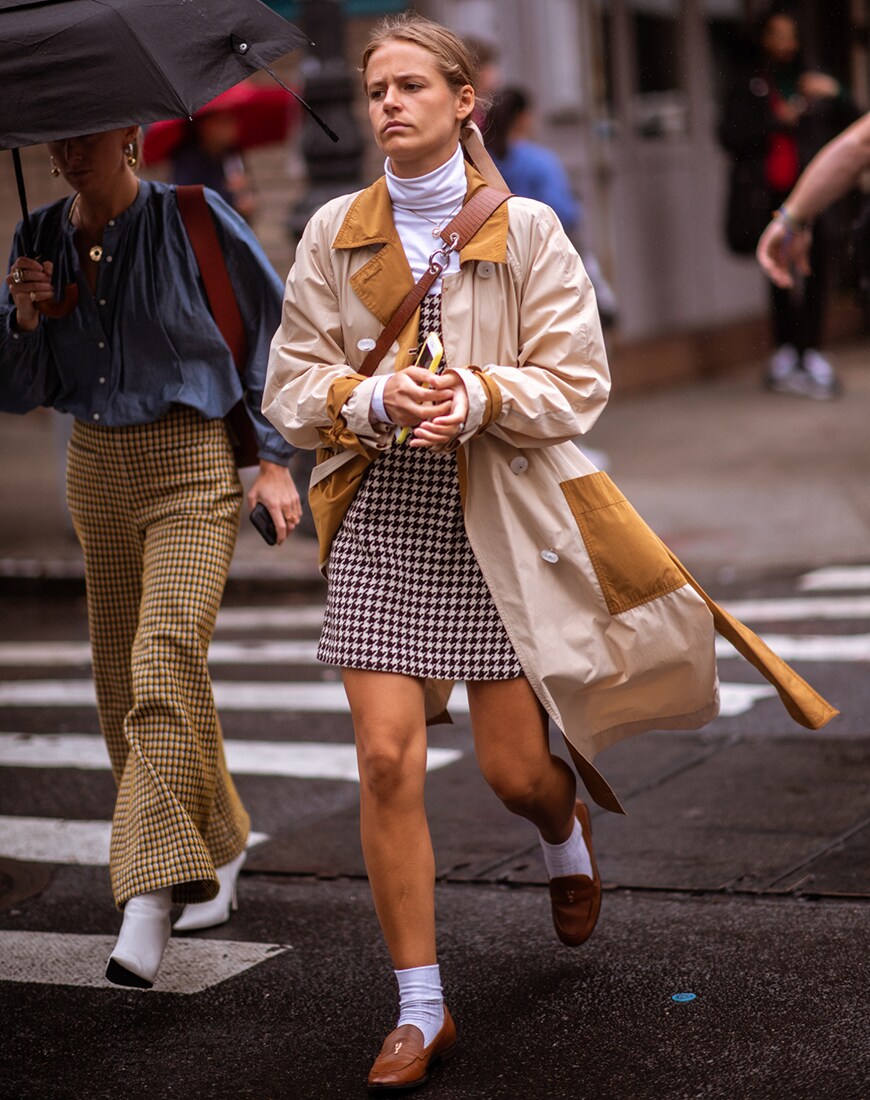 Street-styler in checked pinafore and trench