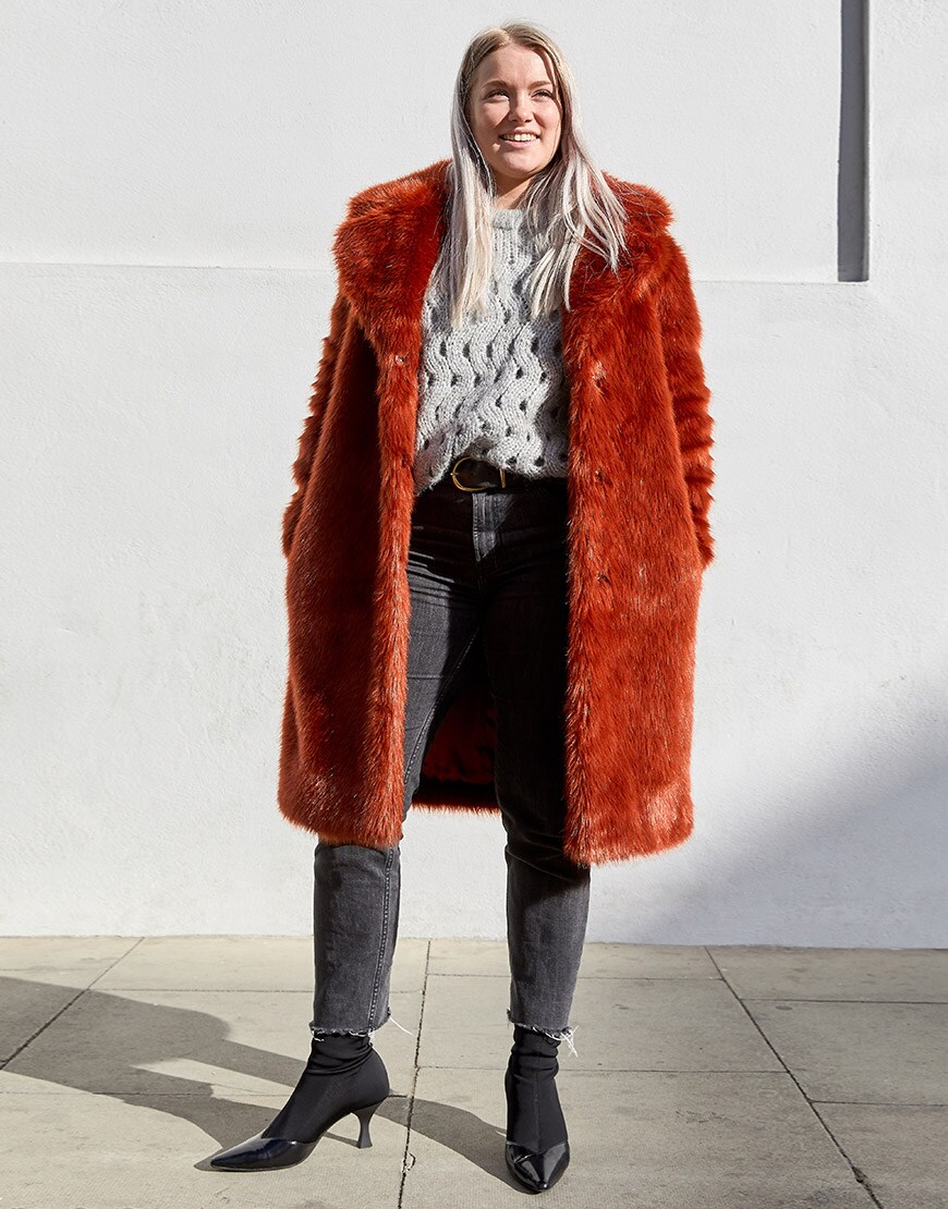 ASOSer wearing a burnt-orange faux-fur coat with a chunky grey jumper and black jeans | ASOS Style Feed