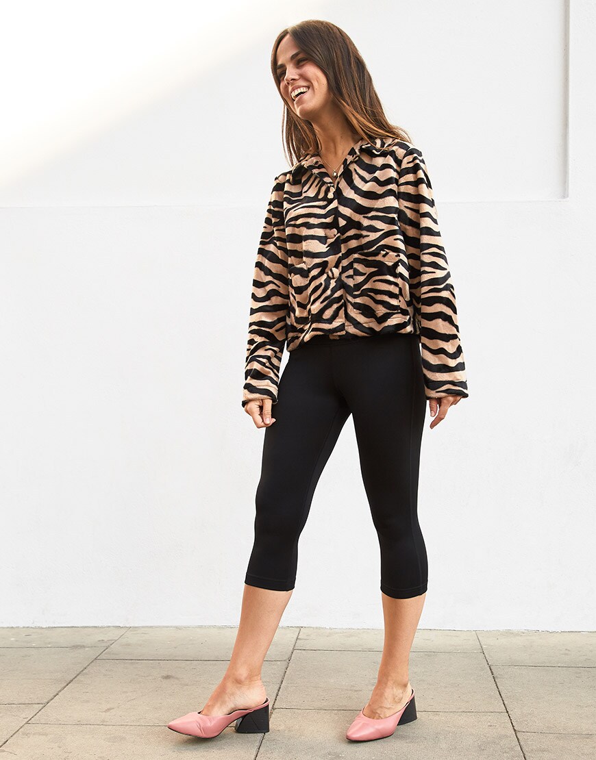 ASOSer wearing a tiger print shirt, cropped black leggings and pointed pink heels | ASOS Style Feed