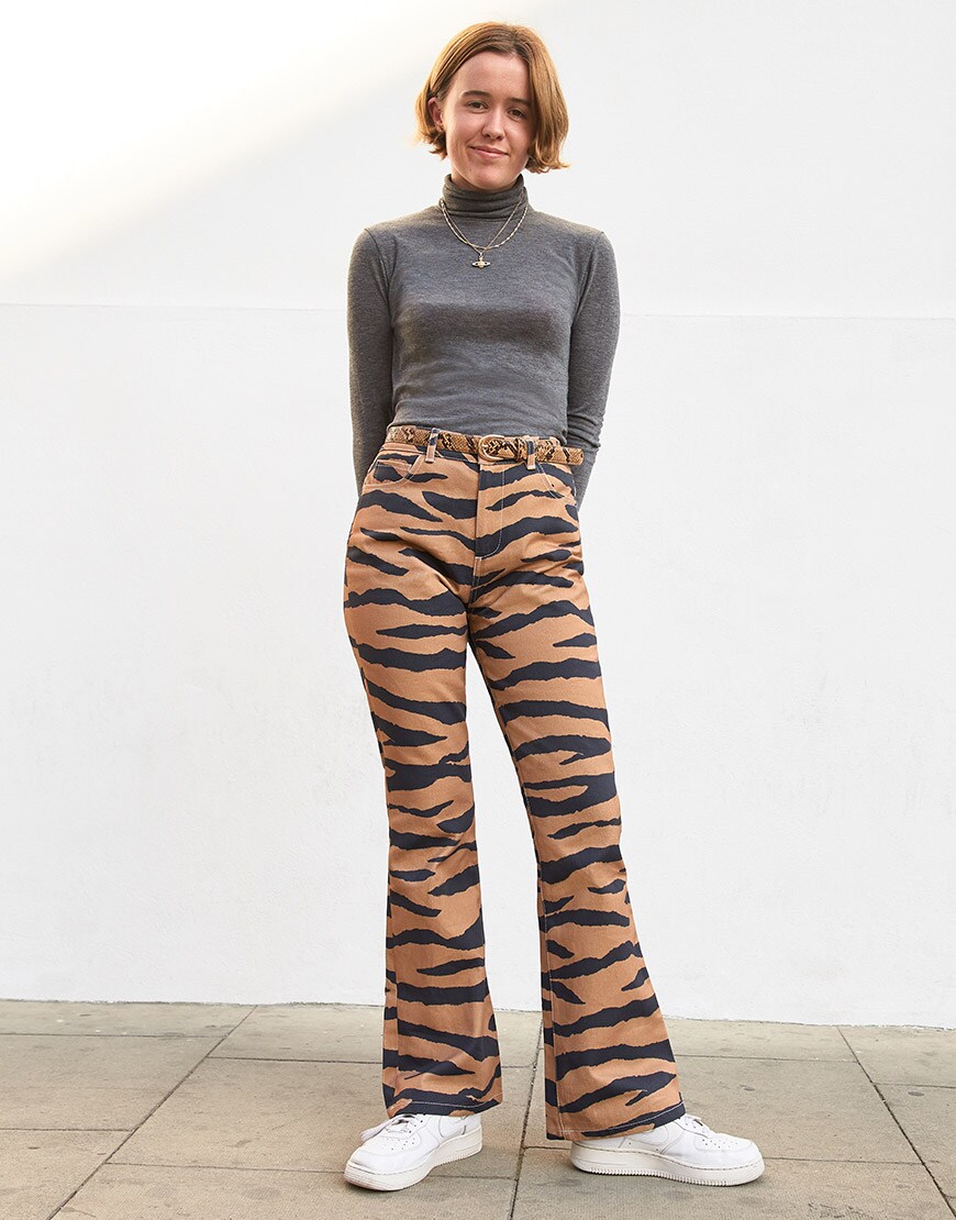 ASOSer wearing a grey roll-neck, tiger print flares and white trainers | ASOS Style Feed