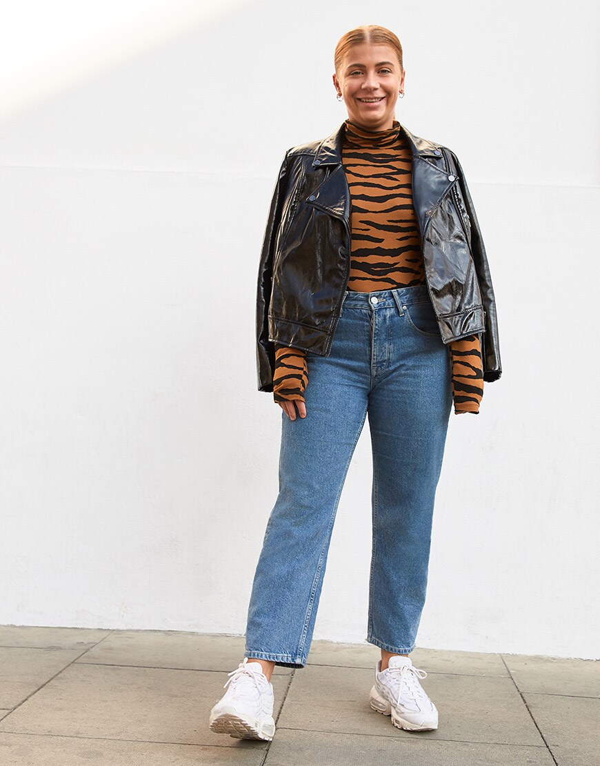 ASOSer wearing a tiger print roll-neck, patent biker jacket and blue jeans | ASOS Style Feed
