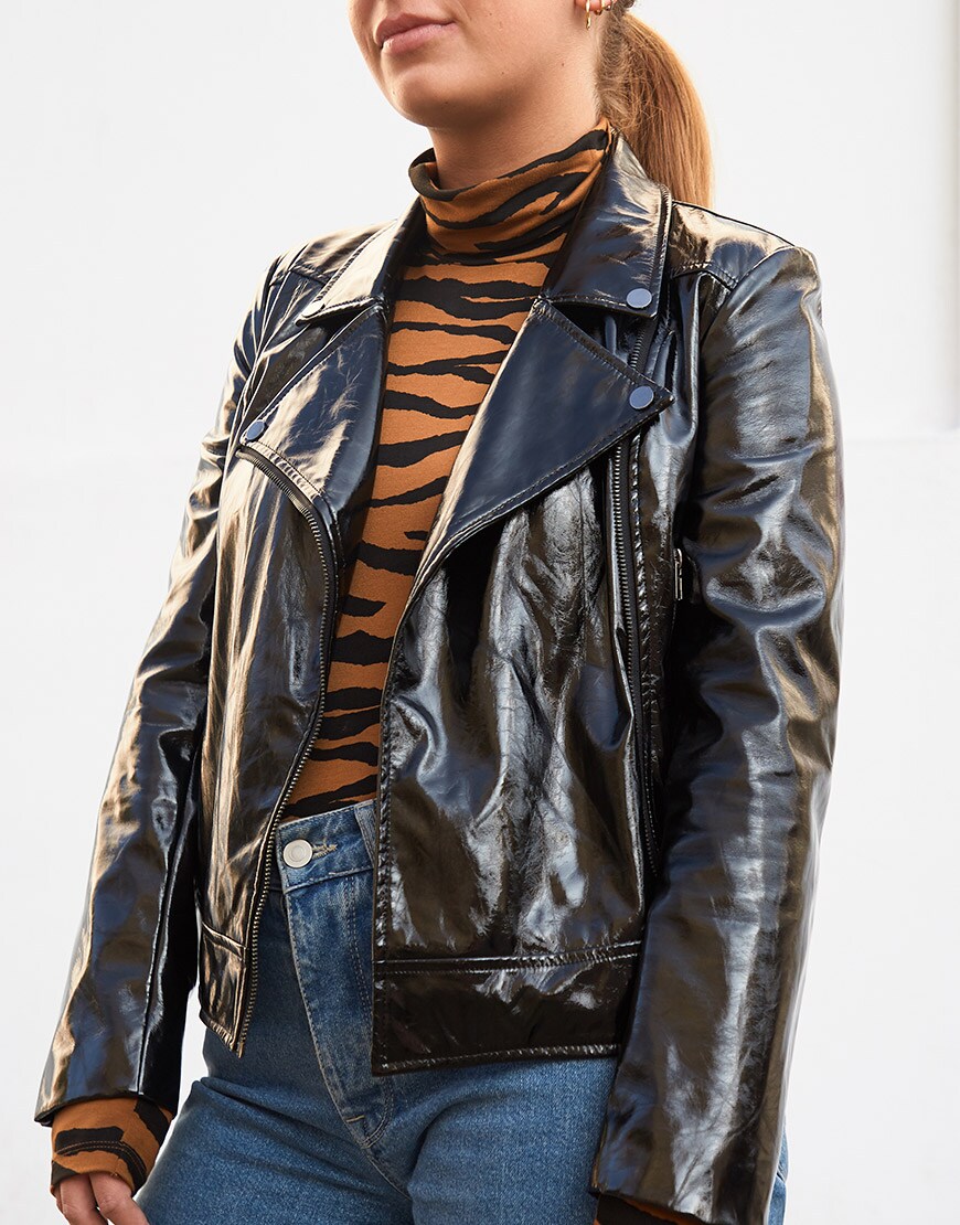 ASOSer wearing a tiger print roll-neck, patent biker jacket and blue jeans | ASOS Style Feed