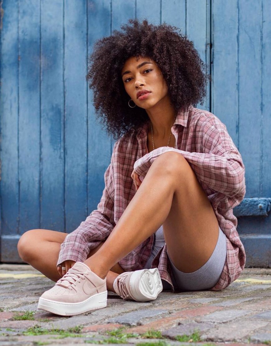 ASOS Lesley wearing plaid shirt with legging shorts and Nike sneakers