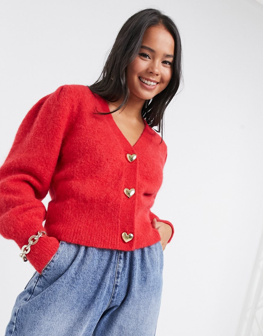 Model wearing & Other Stories gold heart button puff sleeve cardigan in red