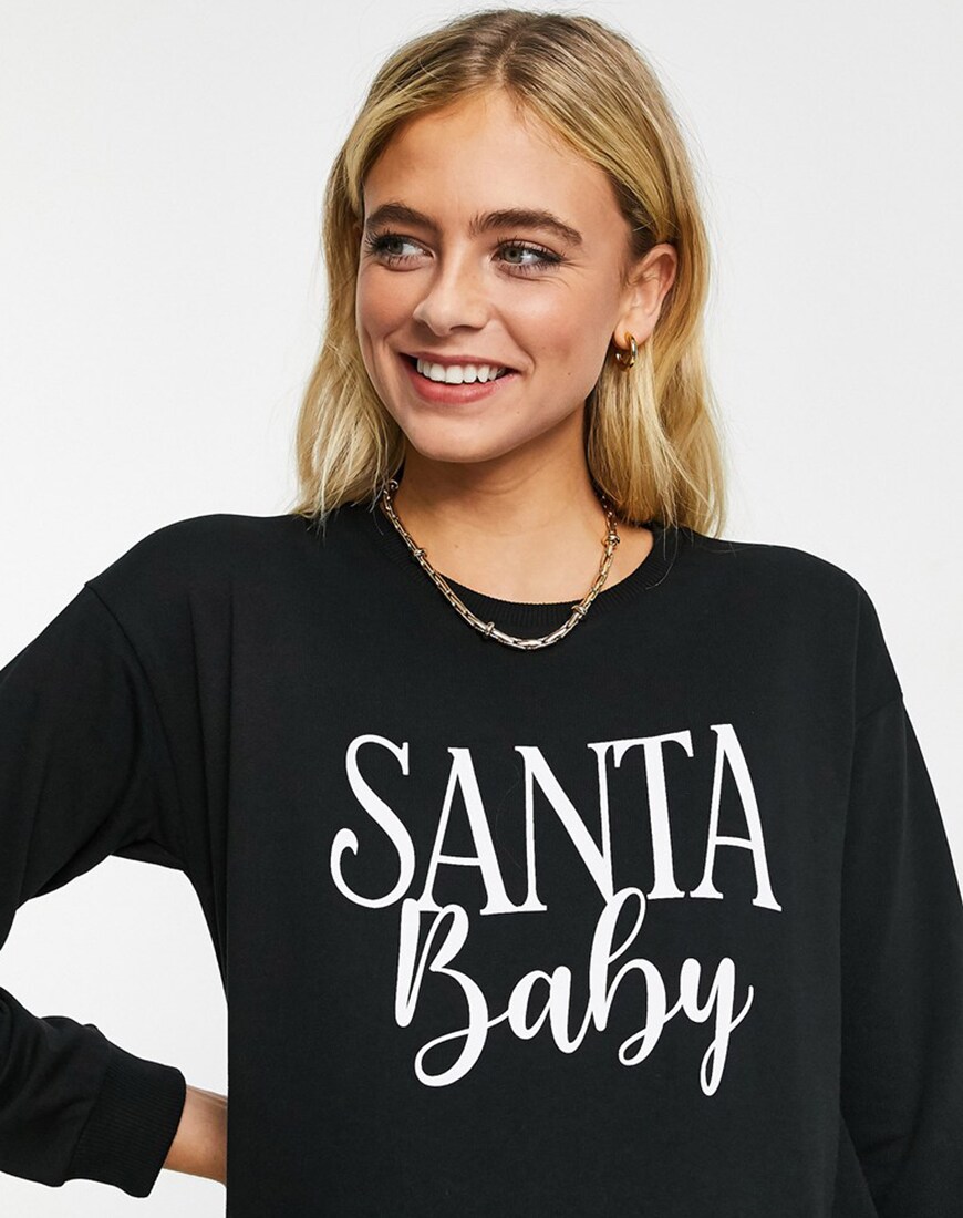 Model wearing ASOS DESGIN Maternity christmas exclusive santa baby sweat in black