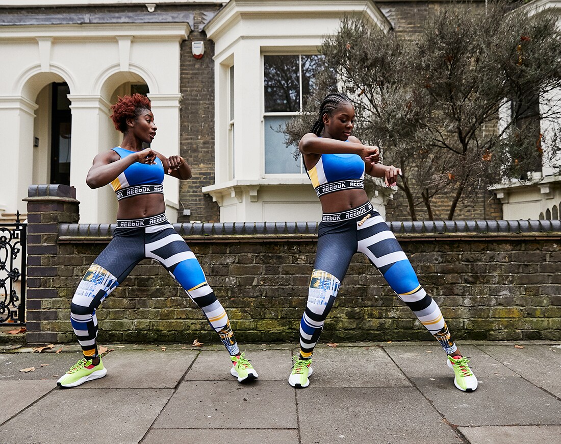 A picture of two women dancing in Reebok sportswear. Available on ASOS.