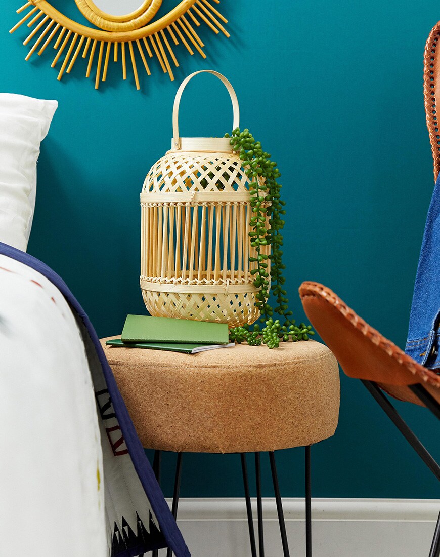 A picture of a bamboo lantern holding a plant by ASOS SUPPLY. Available at ASOS.