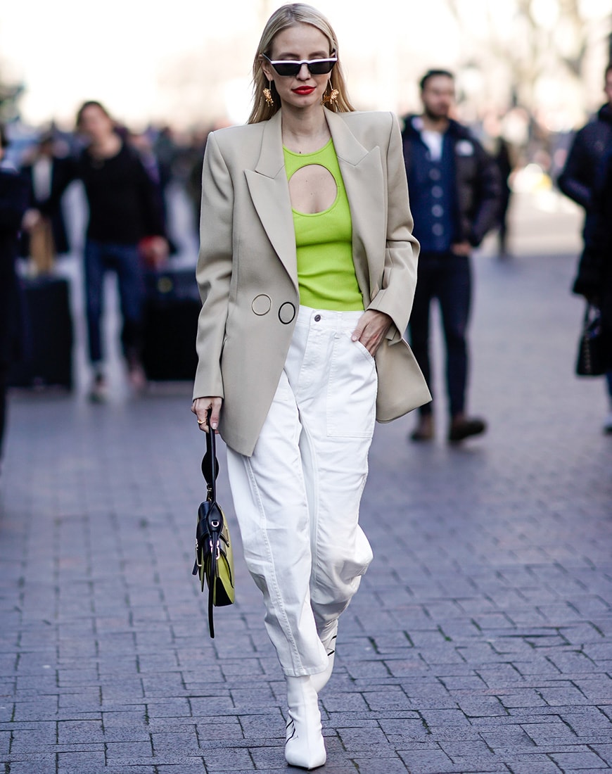 Street style image of a neon top and beige jacket | ASOS Style Feed