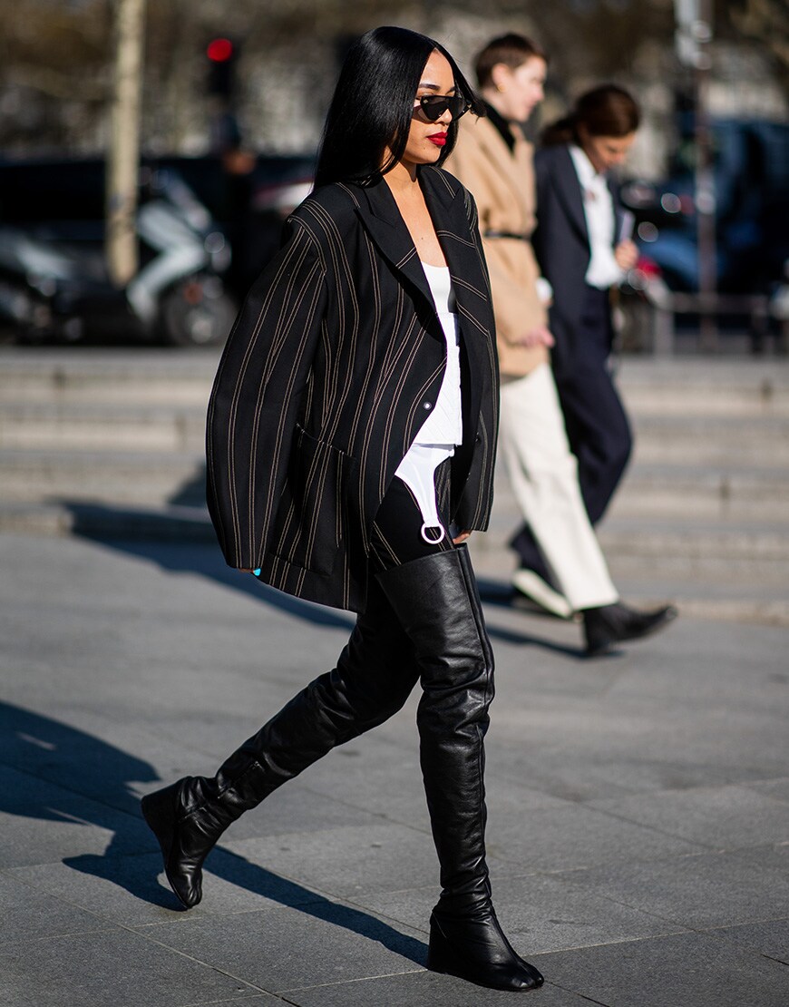Street style picture of Aleali May in a black blazer and over the knee boots | ASOS Style Feed