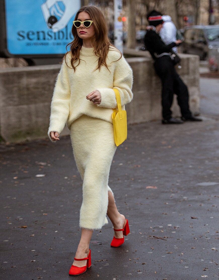 A street style picture of a woman in a yellow jumper and skirt | ASOS STYLE FEED