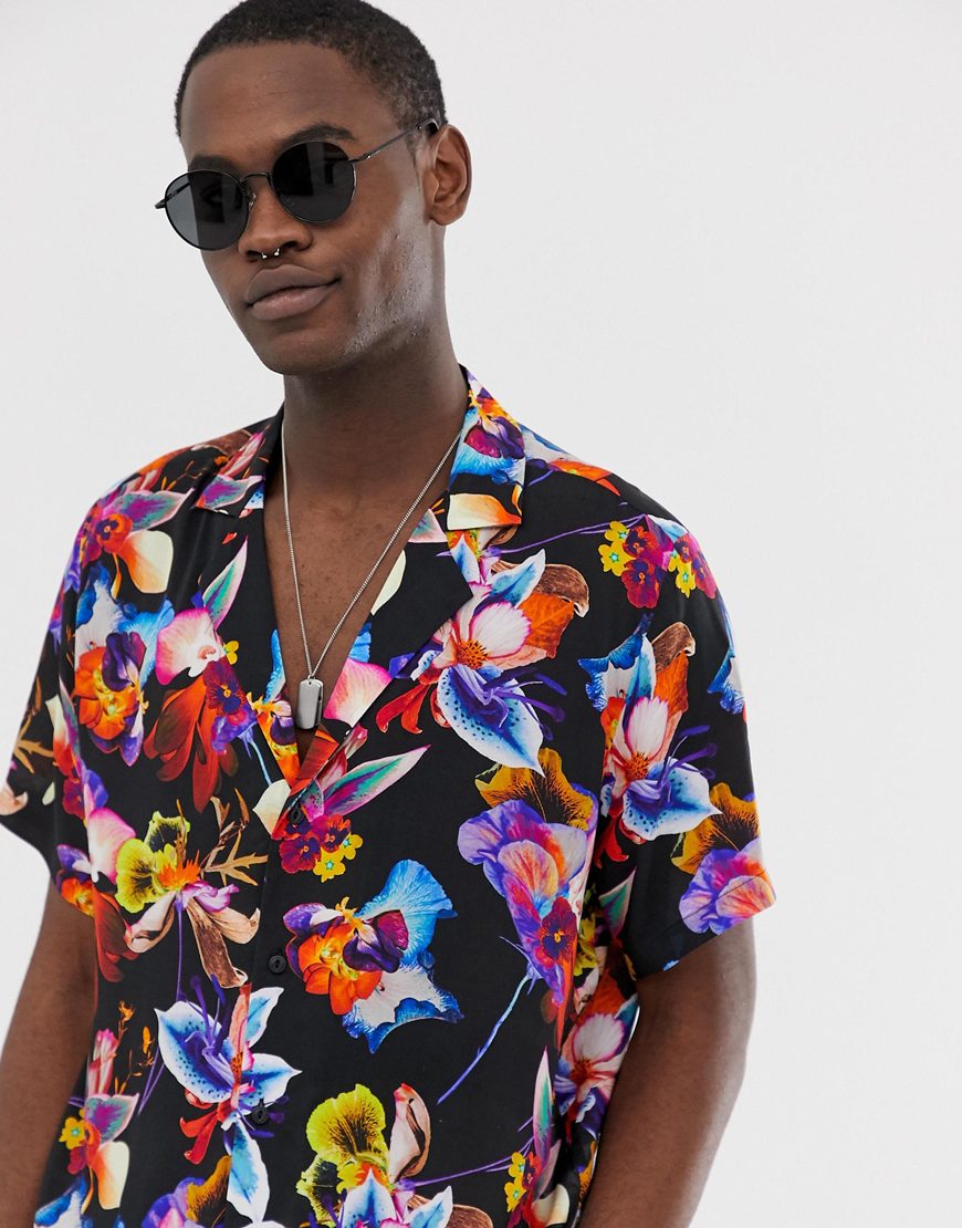 A picture of a model wearing a colourful, floral print shirt. Available at ASOS.