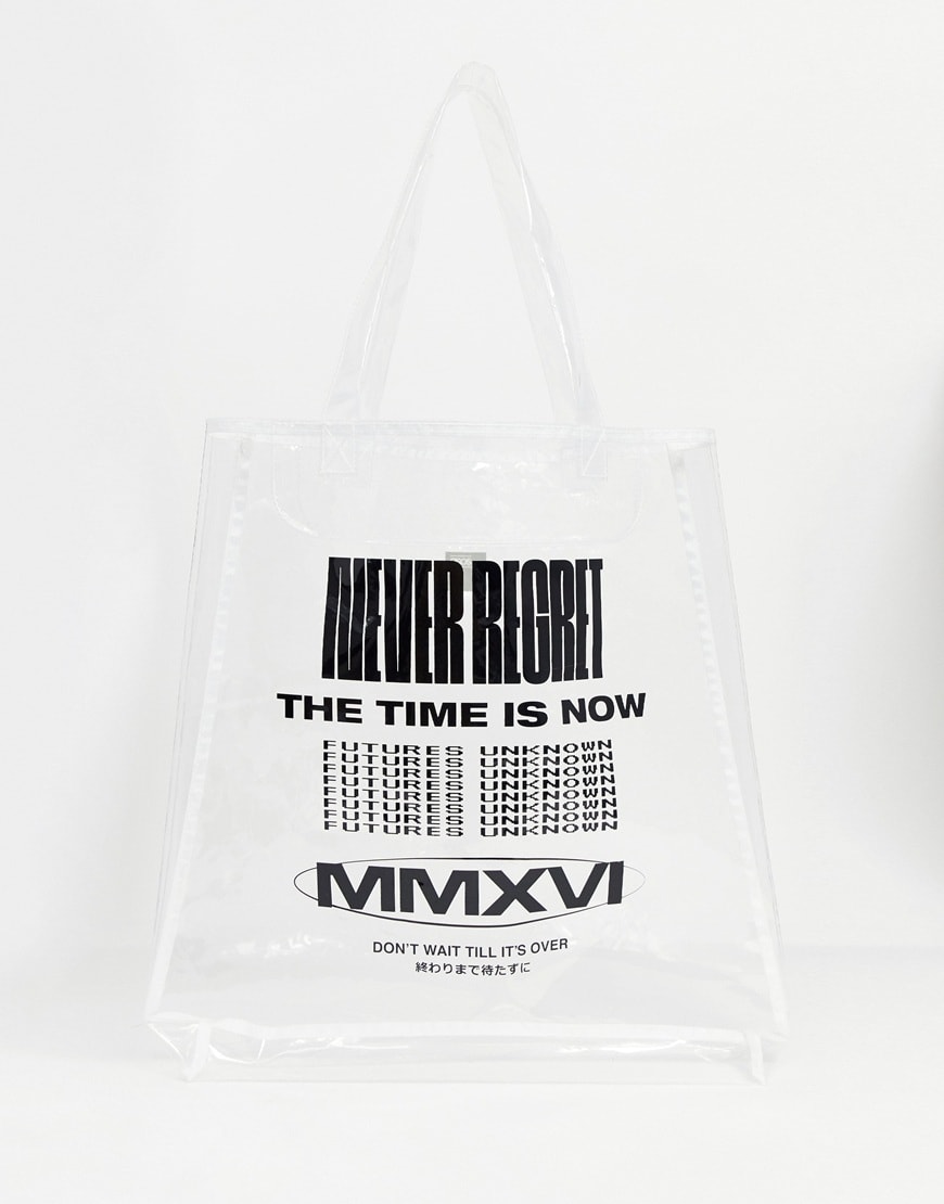 A picture of a clear, plastic tote bag featuring graphic writing. Available at ASOS.