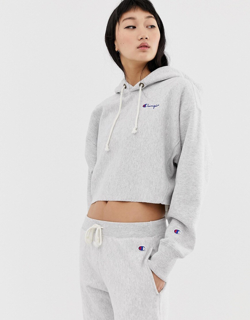 A picture of a model wearing a cropped Champion logo. Available at ASOS.