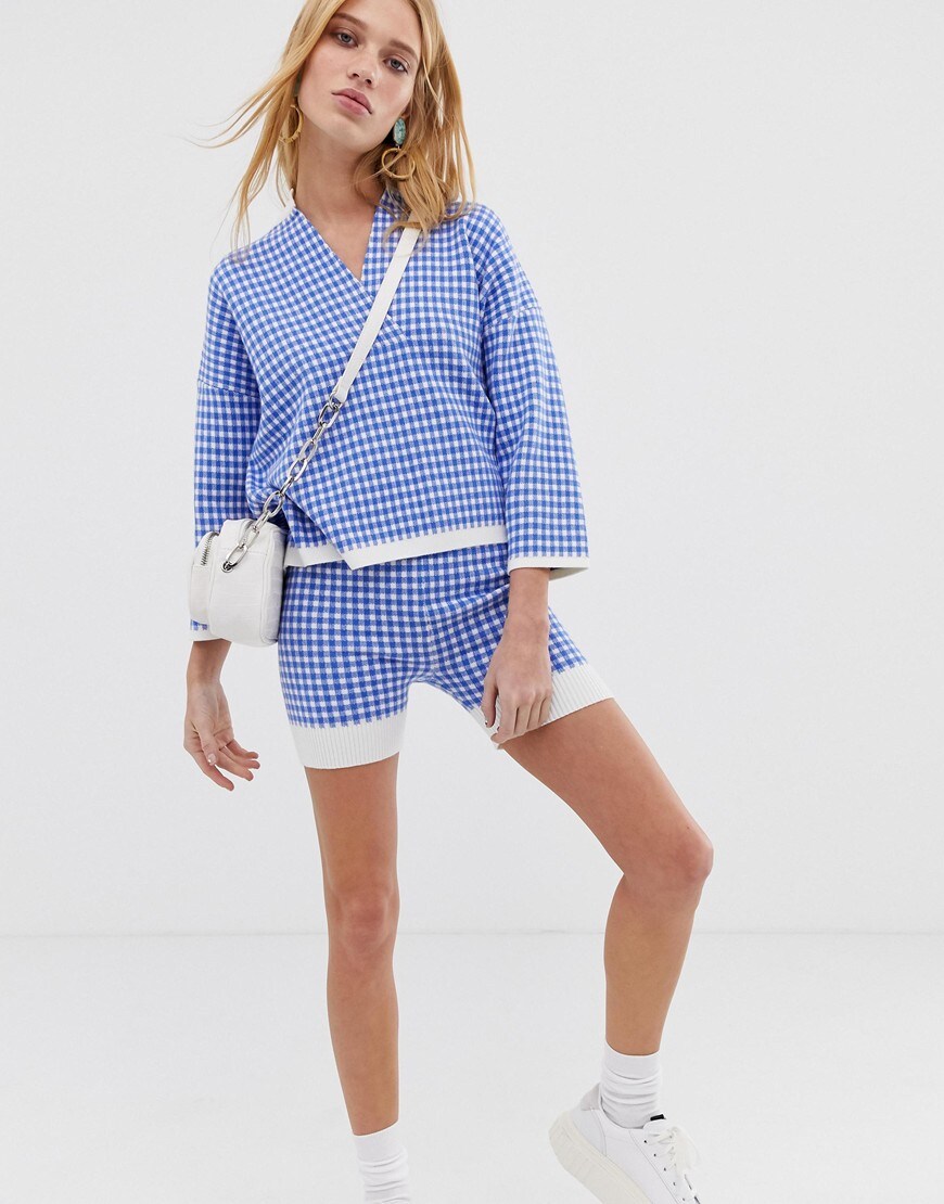 A picture of a model wearing a gingham check knitted co-ord. Available at ASOS.