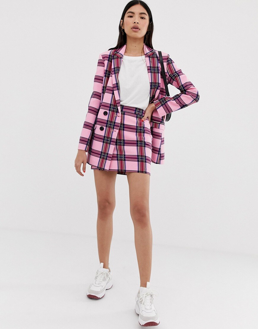A picture of a model wearing a check blazer and skirt co-ord. Available at ASOS.