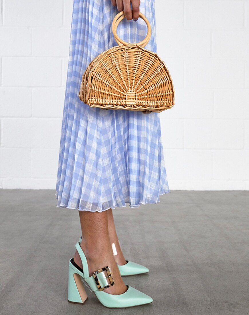 A picture of a model wearing a blue gingham dress and mint-coloured heels. Available at ASOS.