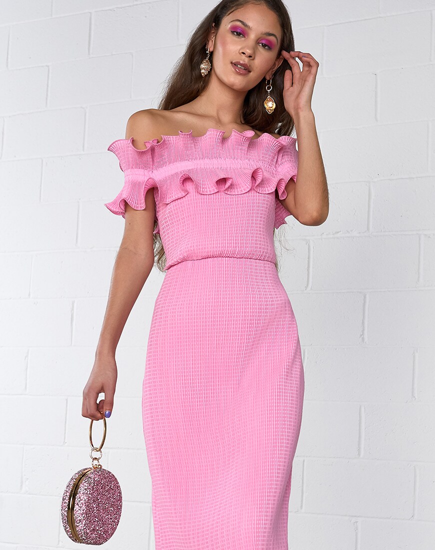 A picture of a model wearing a pink dress with a matching bag and eye makeup. Available at ASOS.