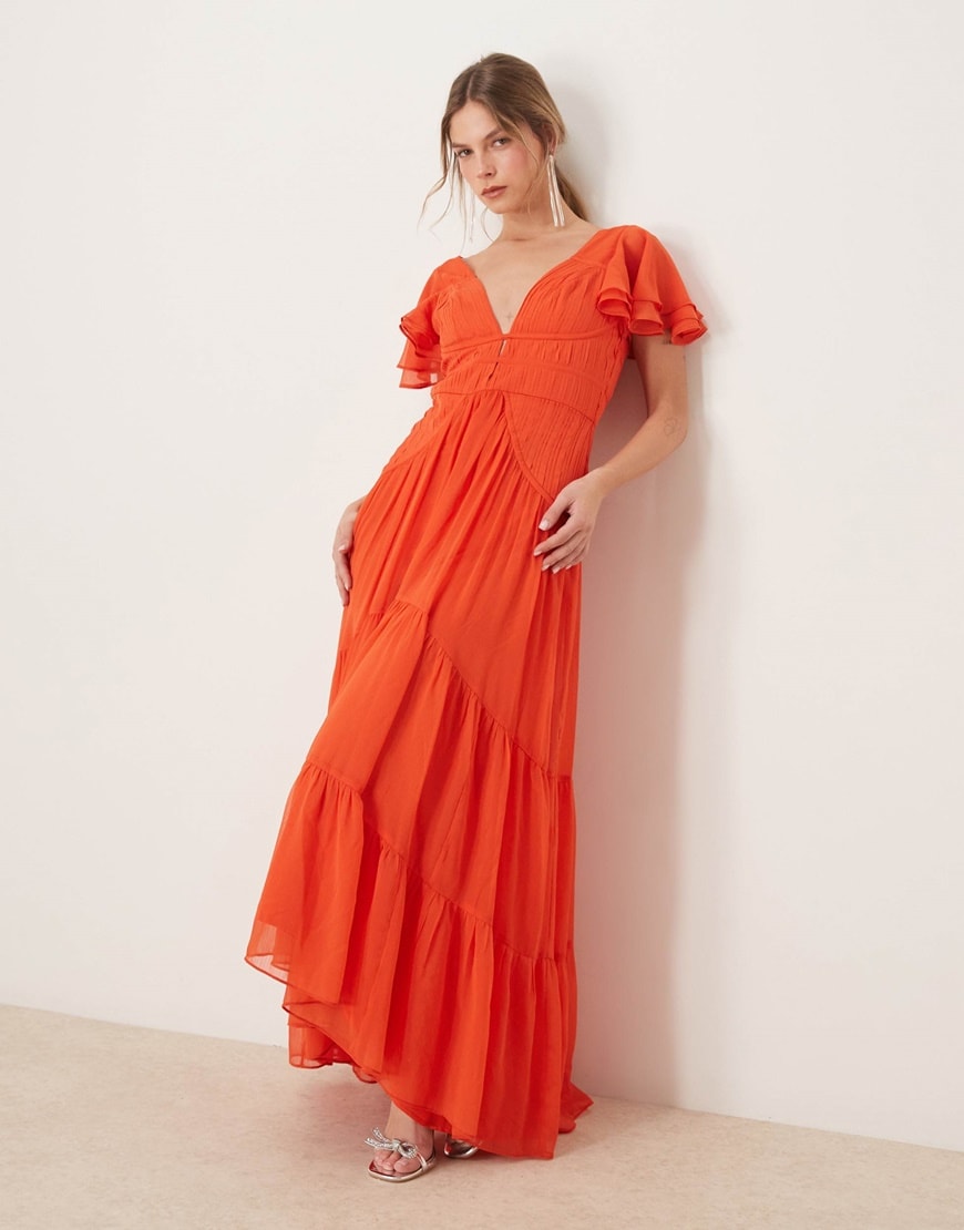 A model wearing a red maxi dress