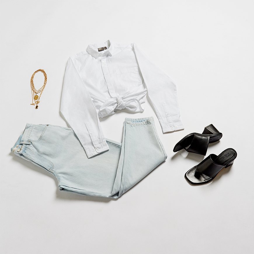 A flat lay of a white shirt and jeans