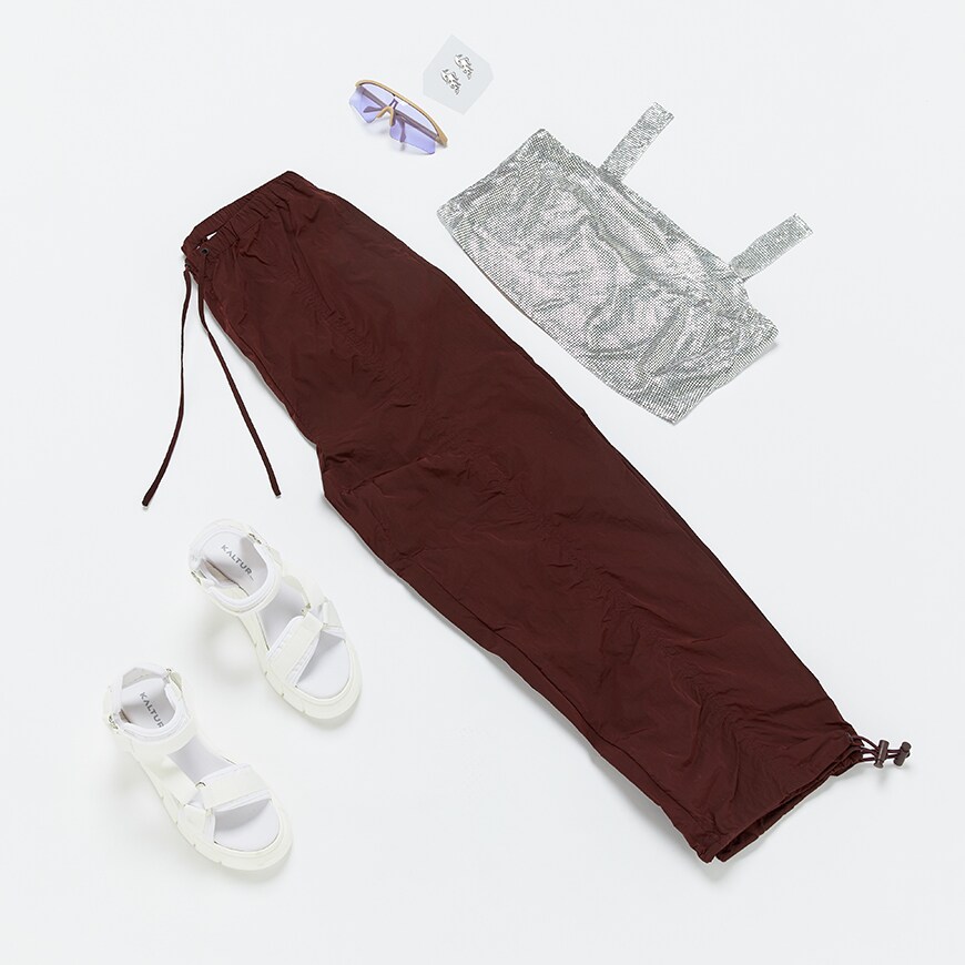 A flat lay of a sequin top and utility trousers | ASO Style Feed