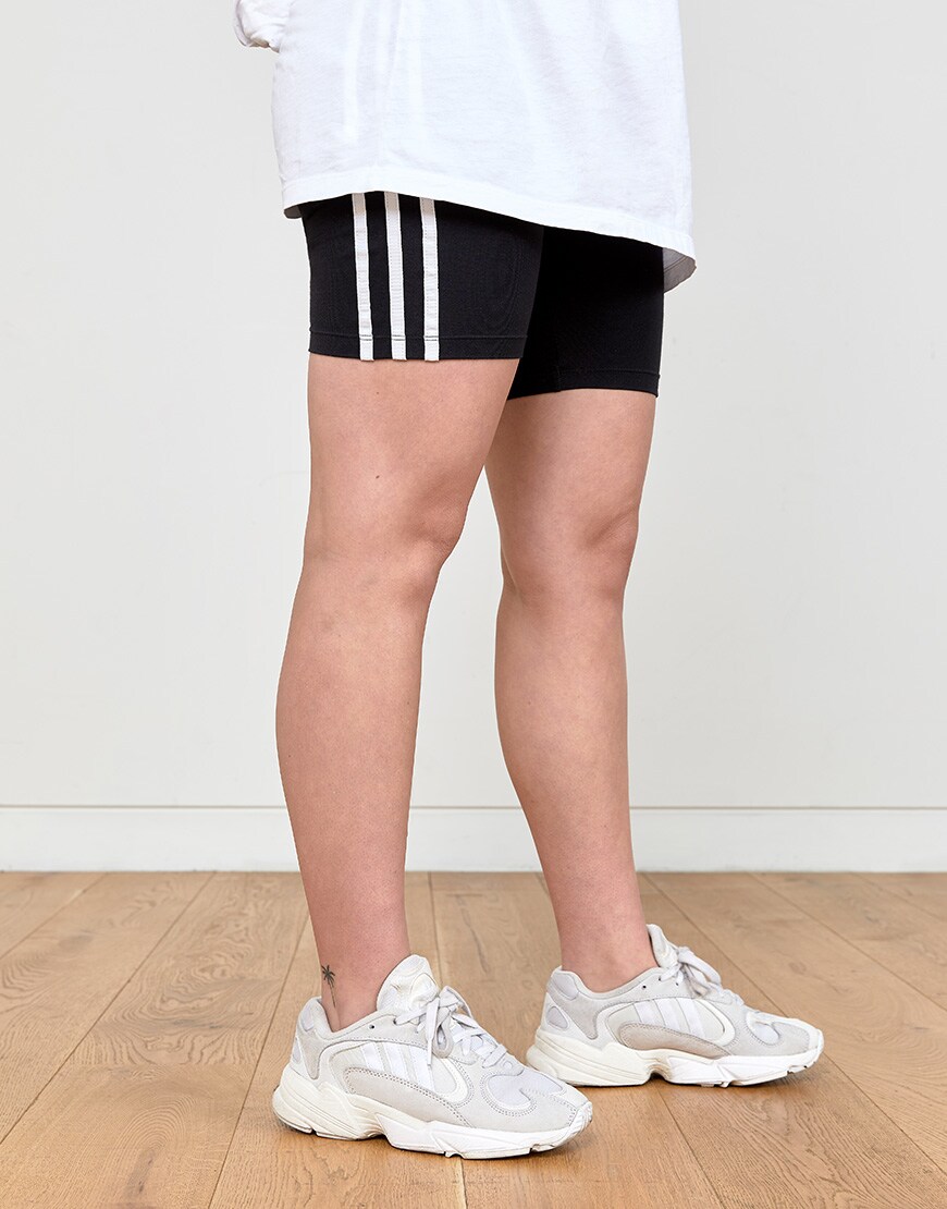 An ASOSer in a white top and legging shorts | ASOS Style Feed