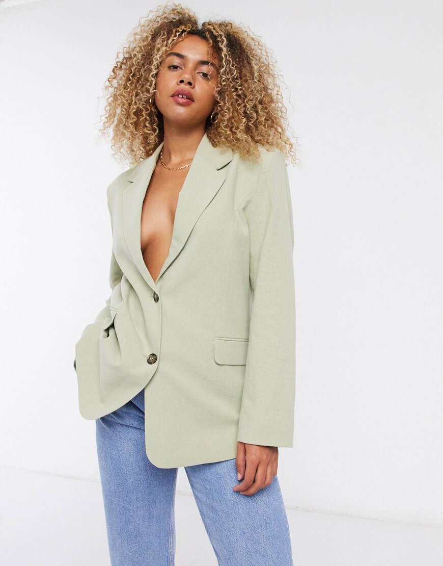A picture of a woman wearing a green blazer by &Other Stories