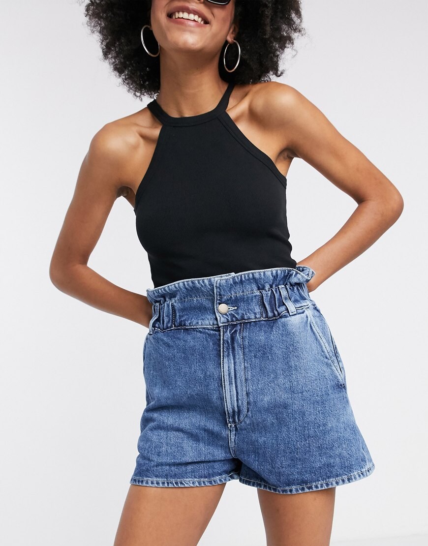 A picture of a woman wearing a pair of denim shorts by & Other Stories | ASOS Style Feed