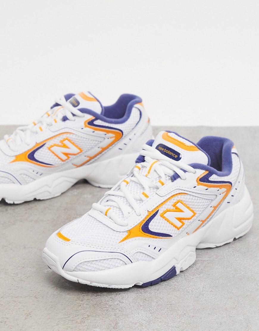 Picture of white and yellow trainers by New Balance