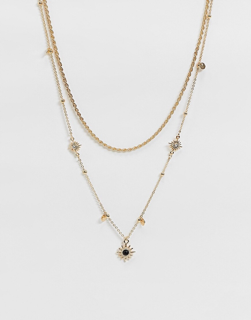 A picture of a gold-tone necklace with sun and star pendants by ASOS DESIGN | ASOS Style Feed