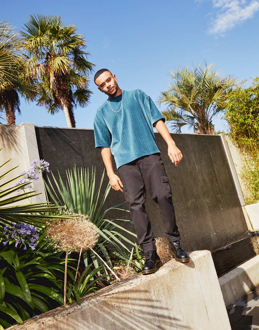 An image of a man wearing a green t-shirt by ASOS Design | ASOS Style Feed