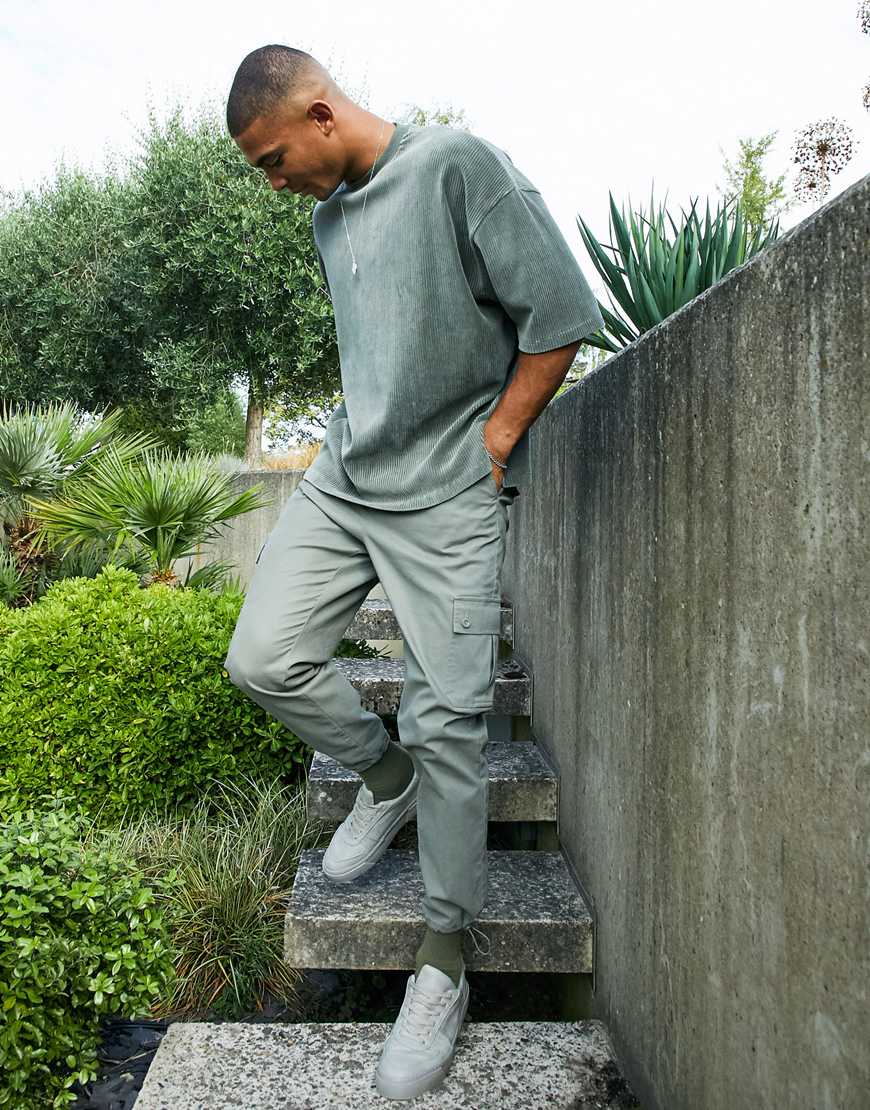 An image of a man wearing khaki trousers by ASOS Design | ASOS Style Feed