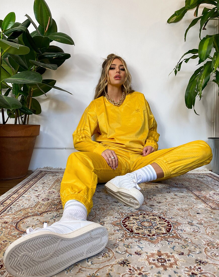 A picture of model and blogger Delilah Belle wearing a tracksuit set from the adidas Originals Comfy Cord collection. Available at ASOS | ASOS Style Feed