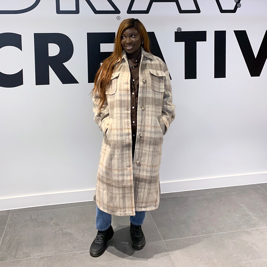 Bim standing in front of a white wall with black printed words | ASOS Style Feed