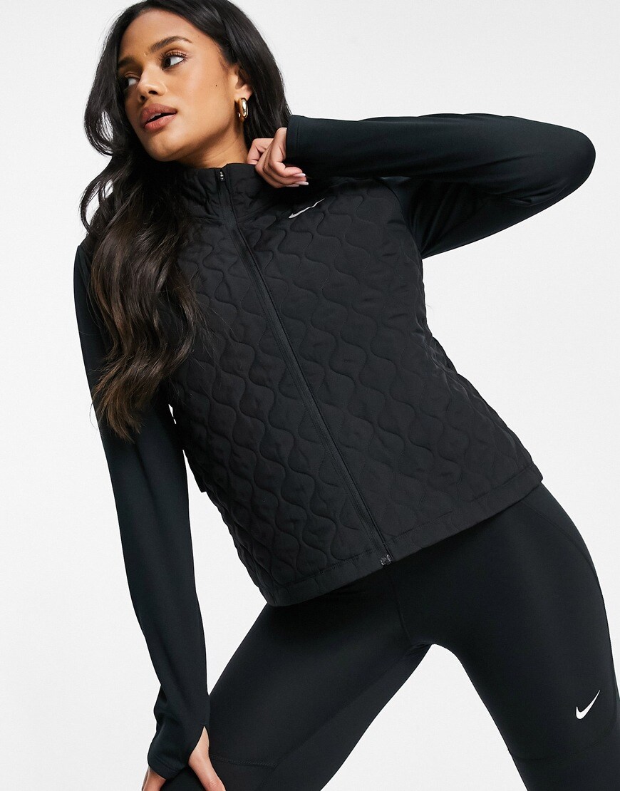 Model wearing black padded Nike running jacket