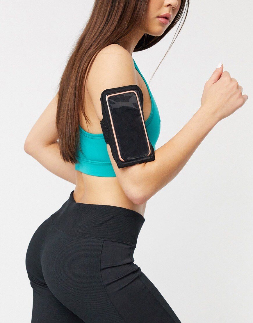 Model wearing ASOS 4505 running arm band for phone