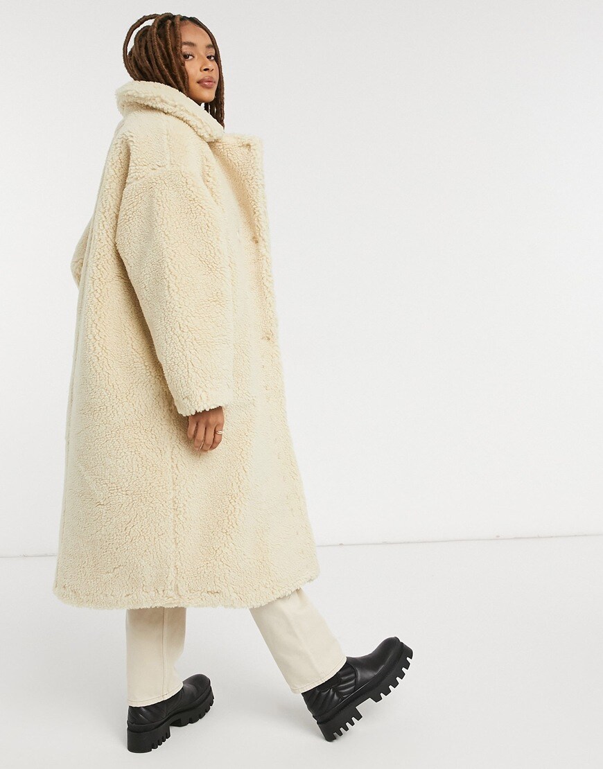 Model wearing Monki Teddy borg coat in off white