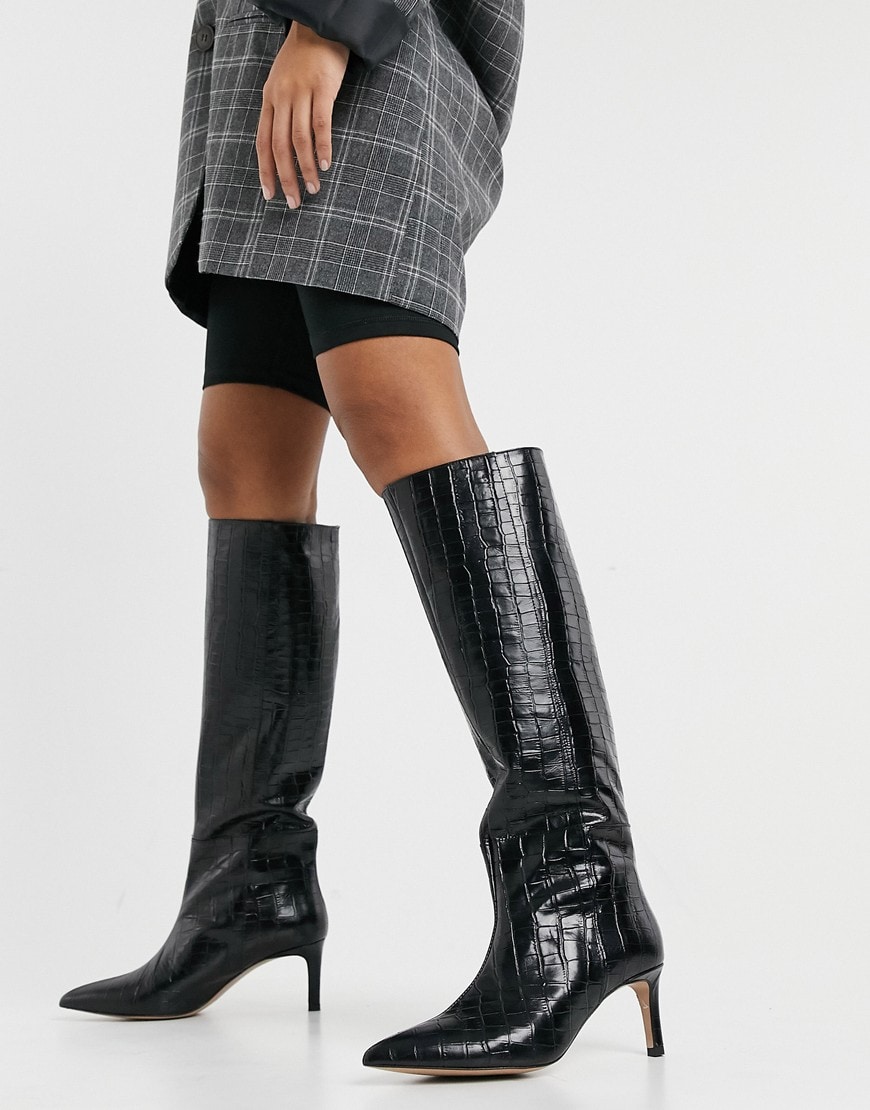An image of a woman wearing a pair of black boots by & Other Stories | ASOS Style Feed
