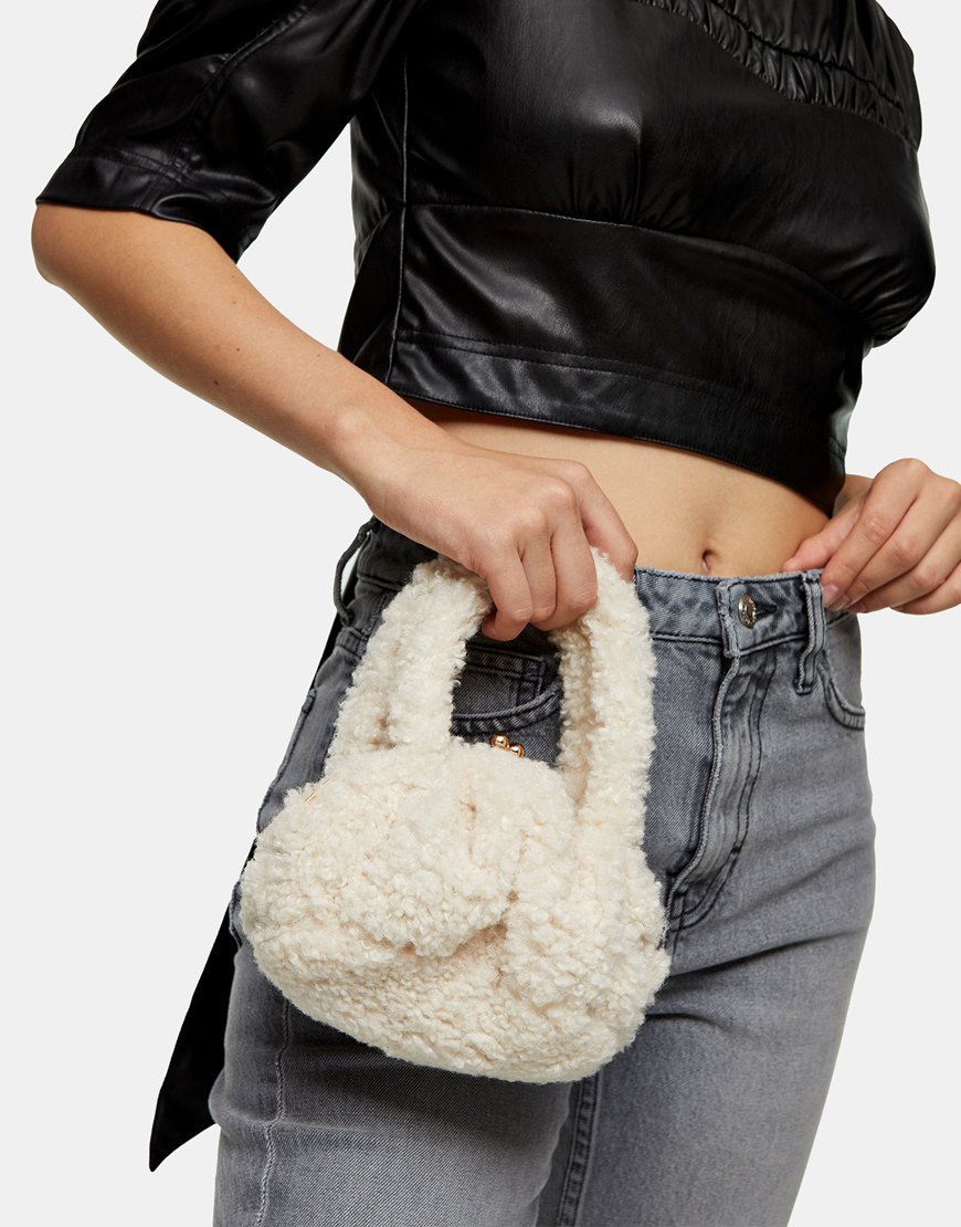 An image of a woman wearing an ivory borg bag by Topshop | ASOS Style Feed