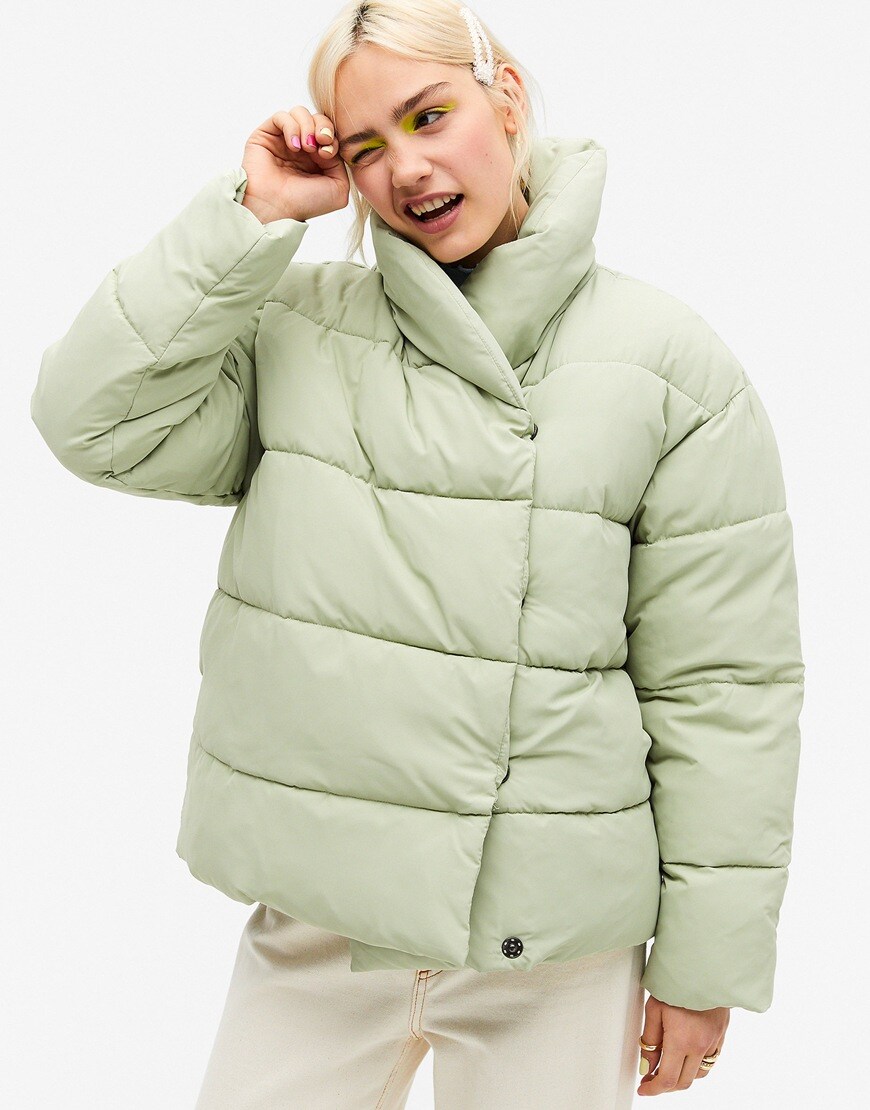 Model wearing Monki Paloma recycled short padded jacket in sage green